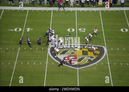 BALTIMORE, MARYLAND, JAN 20: A general overall view as Baltimore Ravens quarterback Lamar Jackson (8) hands the ball off to running back Justice Hill (43) against the Houston Texans at midfield on the Ravens logo during the AFC Divisional Playoff game at M&T Bank Stadium on January 20, 2024 in Baltimore, Maryland. The Ravens defeated the Texans 34-10. Stock Photo