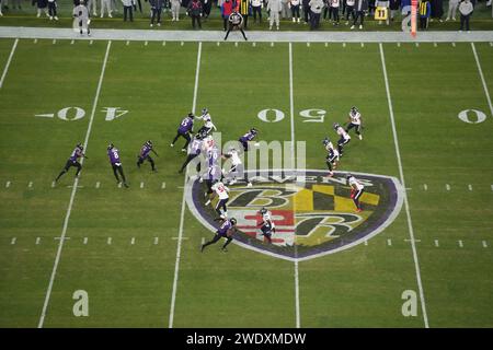 BALTIMORE, MARYLAND, JAN 20: A general overall view as Baltimore Ravens quarterback Lamar Jackson (8) hands the ball off to running back Justice Hill (43) against the Houston Texans at midfield on the Ravens logo during the AFC Divisional Playoff game at M&T Bank Stadium on January 20, 2024 in Baltimore, Maryland. The Ravens defeated the Texans 34-10. Stock Photo