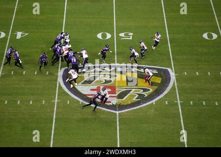 BALTIMORE, MARYLAND, JAN 20: A general overall view as Baltimore Ravens quarterback Lamar Jackson (8) hands the ball off to running back Justice Hill (43) against the Houston Texans at midfield on the Ravens logo during the AFC Divisional Playoff game at M&T Bank Stadium on January 20, 2024 in Baltimore, Maryland. The Ravens defeated the Texans 34-10. Stock Photo