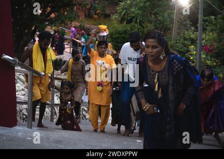 Georgetown, Penang, Malaysia - February 05, 2023: Female Hindu devotee climbing stairs to temple at Thaipusam festival Stock Photo