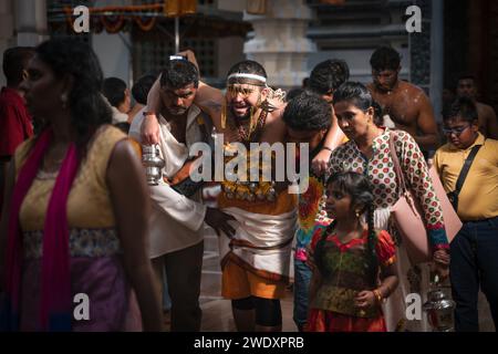 Georgetown, Penang, Malaysia - February 05, 2023: Hindu devotee with painful face expression entering the temple with help at Thaipusam festival Stock Photo