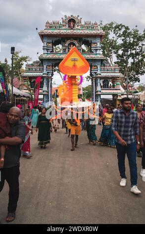 Georgetown, Penang, Malaysia - February 05, 2023: Hindu devotee with kavadi entering the temple arch at Thaipusam festival Stock Photo