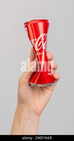 Berlin Germany December 21 2023 Squeezed compressed metal can, tin bottle in hand Stock Photo