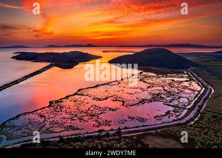 Sunset at Valtos bay, close the the Delta of Kalamas ('Thyamis') river, Thesprotia, Epirus, Greece. In the background, on the horizon, Corfu island. Stock Photo