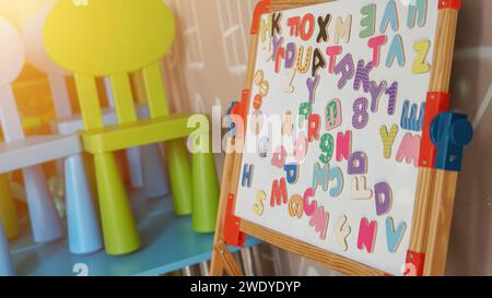 Magnetic learning multi-colored numbers on a white board at the primary school. Educative activity for early children development. Stock Photo