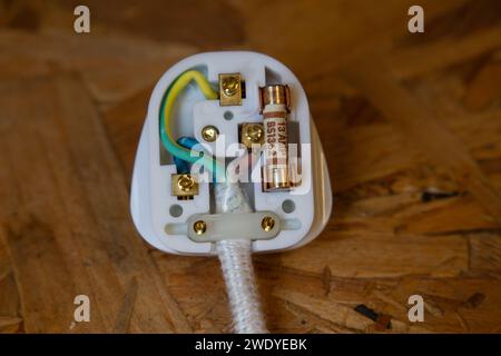 Close-up of a UK 3 pin mains electrical plug showing the wire colours and 13 amp fuse Stock Photo