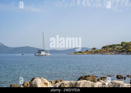 Looking towards the greek mainland from a beach near Elia Beach on the greek island of Meganisi with yacht Stock Photo