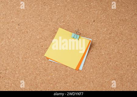 Several multi-colored sheets paper fastened with a paper clip. Stock Photo