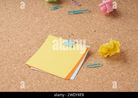 Several multi-colored sheets paper fastened with a paper clip. Stock Photo