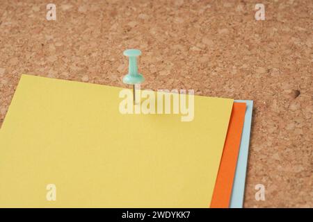 Several multi-colored sheets paper fastened with a paper clip. Stock Photo