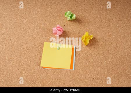 Several multi-colored sheets paper fastened with a paper clip. Stock Photo