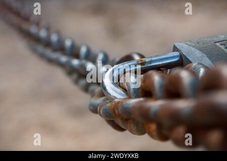 Chain with rust and padlock to close the path in the natural area of San Antonio de Alcoi, Spain Stock Photo