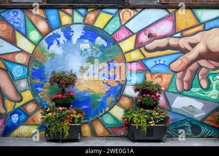 Peace and unity mural painted on the wall of a city square in Belfast, Northern Ireland. Stock Photo