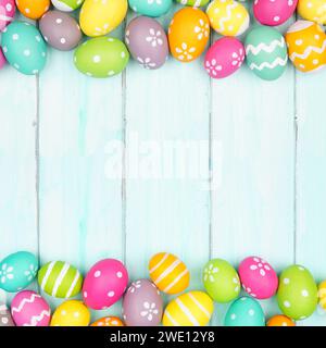 Colorful Easter Egg double border over a soft blue wood background. Copy space. Stock Photo