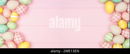 Easter double border with rustic cloth and pastel colored eggs over a pink wood banner background. Overhead view with copy space. Stock Photo