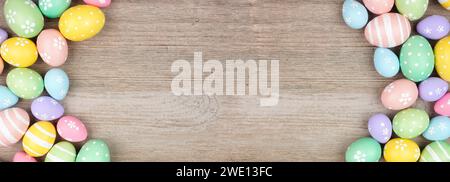 Colorful pastel Easter egg double border. Top view on a light wood banner background. Copy space. Stock Photo
