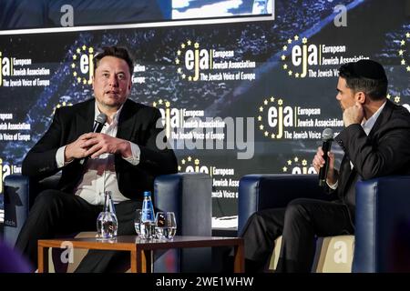 Krakow, Poland. 22nd Jan, 2024. American billionaire, Elon Musk (L) speaks in conversation with Ben Shapiro (R), a Jewish political journalist and broadcaster about antisemitism online during the European Jewish Association (EJA) symposium in the Conference Centre of Hilton Hotel in Krakow. Elon Musk visited Poland on the invitation of EJA to show his support to the Jewish fight against antisemitism. Elon Musk was accused of antisemitism after some antisemitic posts were published on X platform. Credit: SOPA Images Limited/Alamy Live News Stock Photo