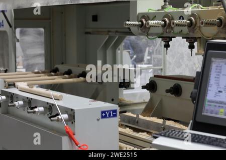 Multi heads CNC furniture carving router machine. Selective focus. Stock Photo