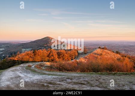 From Pinnacle Hill looking at Jubilee hill, Perseverance hill and North Hill at sunrise in the frost. Malvern hills, Worcestershire, England Stock Photo