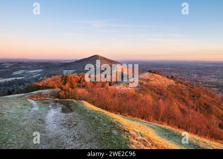 From Pinnacle Hill looking at Jubilee hill, Perseverance hill and North Hill at sunrise in the frost. Malvern hills, Worcestershire, England Stock Photo
