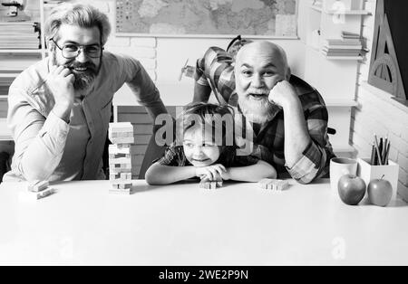 Grangfather, Father and son playing jenga game at home. Stock Photo