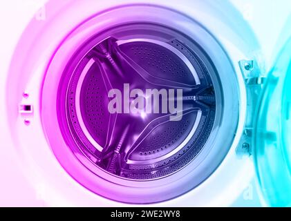 Washing machine drum close up. Washing machine background. Inside the washing machine. Metal washing machine drum. Perforated shiny metal Stock Photo
