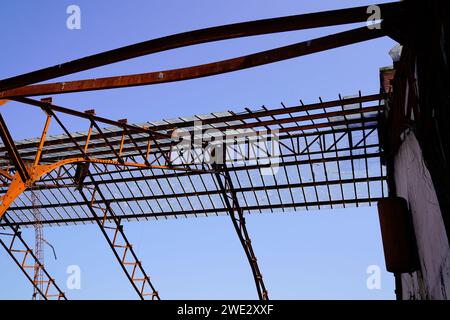 Monumental industrial steel architecture metal construction on derelict manufacturing site in blue sky Stock Photo