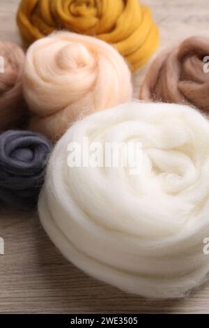Colorful felting wool on wooden table, closeup Stock Photo