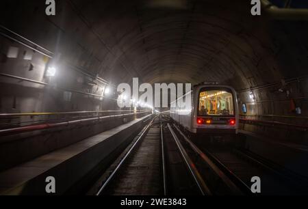 A metro train on the line M5 travels through a tunnel in Milan, Italy. Stock Photo