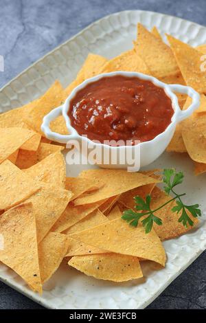 Homemade Mexican Tortilla Corn Chips or Nachos with Tomato Salsa Sauce Dipping Stock Photo