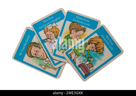 old retro Happy Families playing cards isolated on white background - the Dose Family, Mr Dose the Doctor with wife, son and daughter - UK Stock Photo