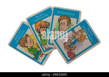 old retro Happy Families playing cards isolated on white background - the Dose Family, Mr Dose the Doctor with wife, son and daughter - UK Stock Photo