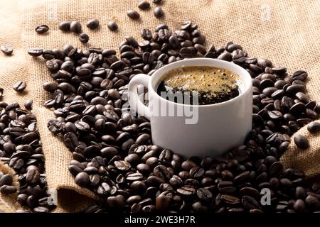 cup of coffee with beans on jute background Stock Photo