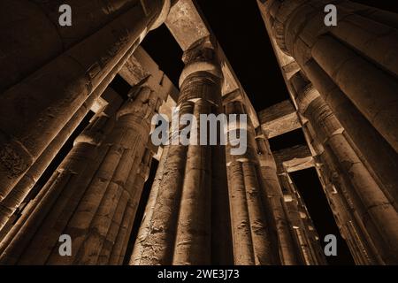 Luxor, Egypt - December 26 2023: Luxor temple colonnade illuminated at night Stock Photo