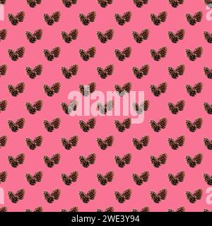 Pattern of natural dried pine cones on hot pink background Stock Photo
