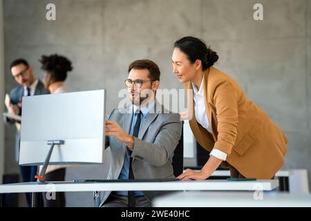Group of diverse multiethnic business people and software developers working as a team in office Stock Photo
