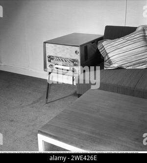 In the 1950s. Interior of a living room with a Philips radio standing on the small table on the side of the sofa. 1956. Svahn ref SVA1 Stock Photo