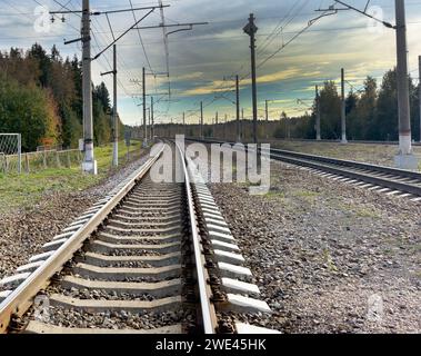 Railway station against beautiful sky at sunset. Industrial landscape with railroad Stock Photo