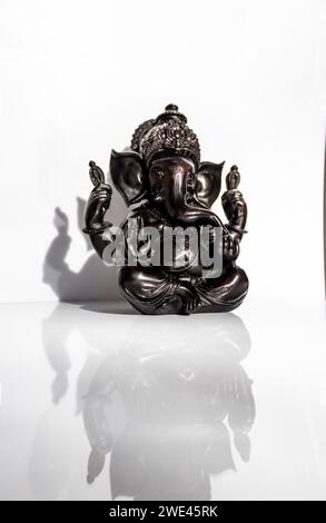 Black figurine of Lord Ganesh with white background Stock Photo