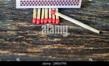 Matches sticks with red head on rustic wooden table Stock Photo