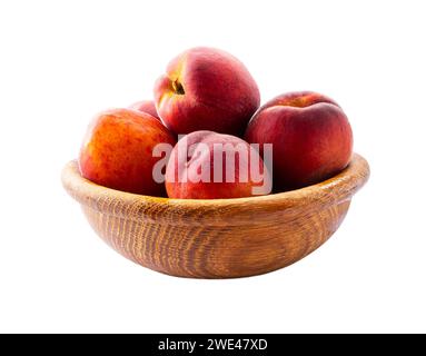 Peaches isolated on white background close-up. Peaches in a wooden bowl. Stock Photo