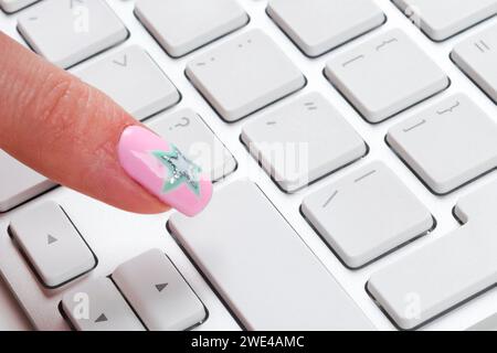 Close up view of a Finger Pushing on a empty Button of computer Keyboard. Finger Pressing a Slim Aluminum Keyboard Button. Modern Laptop Keyboard. Emp Stock Photo