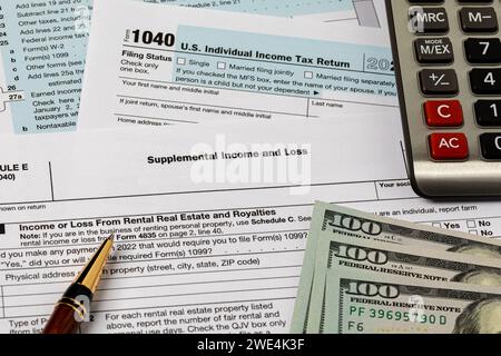 Supplemental income form for federal income tax return and calculator. Federal tax return, income tax and tax refund concept Stock Photo