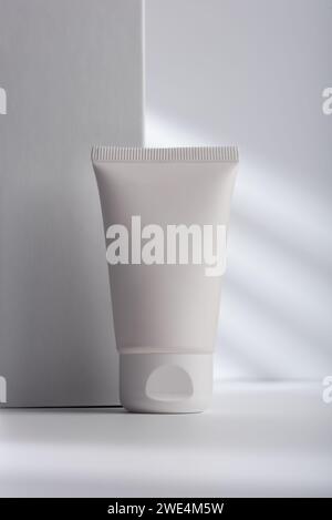 White face cream tube on light gray background for cosmetic mock-up. Healthy cosmetology, skincare and beauty treatment creative concept. Stock Photo