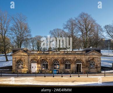 The Pump Room, now Buxton Visitor Centre with The Slopes in the distance, in snow. Derbyshire. UK Stock Photo