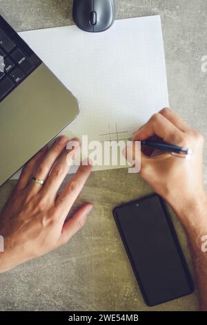 person using laptop, working and taking notes Stock Photo