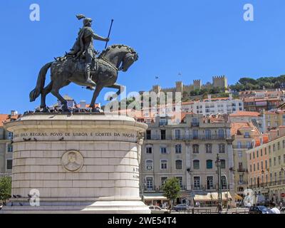 Praca da Figueira Square in the Baixa district in Lisbon , Portugal. King Dom Joao I statue with the Sao Jorge Castle on top of hill Stock Photo