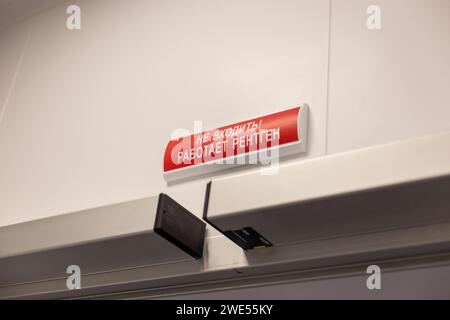 Warning sign in Russian above a door indicating X-ray usage, text reads :Do Not Enter. X-ray in operation Stock Photo