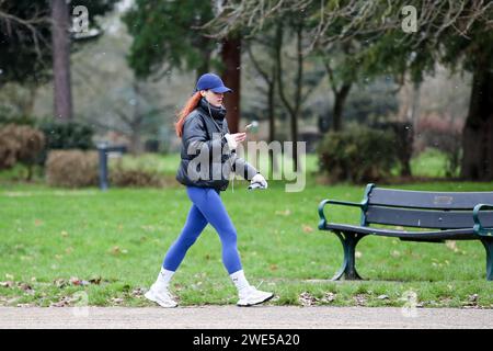 London, UK. 08th Jan, 2024. A woman seen using her phone while walking in a park. According to the Met Police on average 169 mobile phones are stolen in a day, in London. Credit: SOPA Images Limited/Alamy Live News Stock Photo