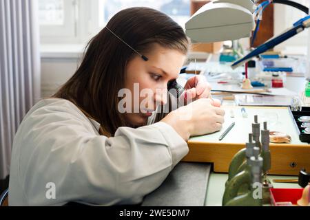 Woman repairing watch, Le sentier, Vallee de Joux, Switzerland Stock Photo